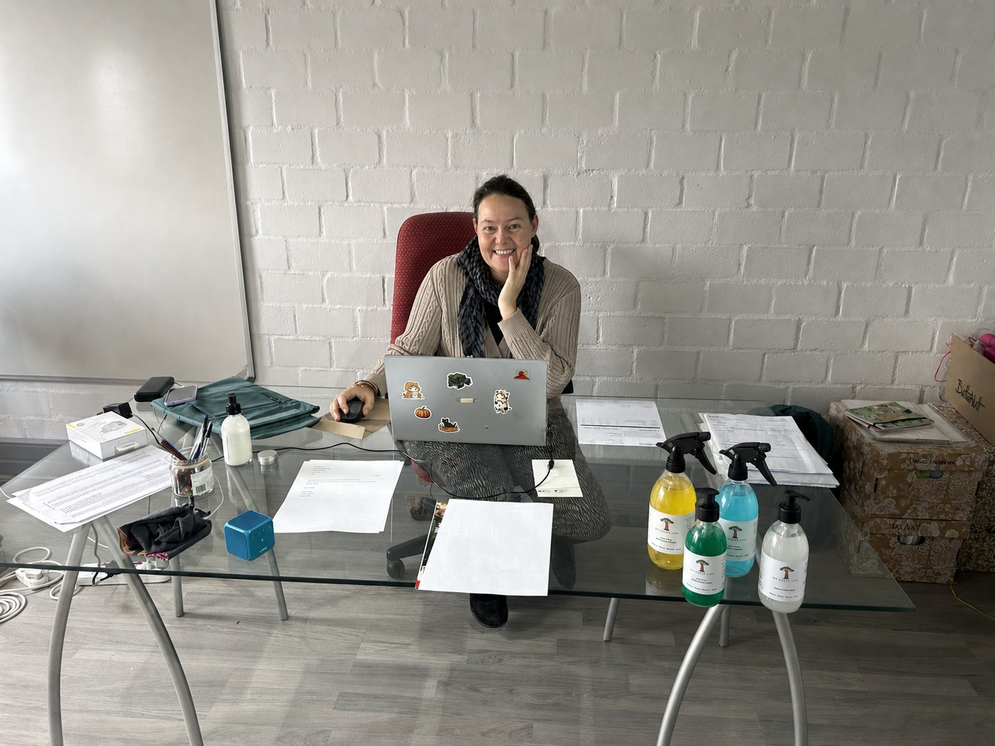 Symantha Van Niekerk working at her desk with a selection of MGL products